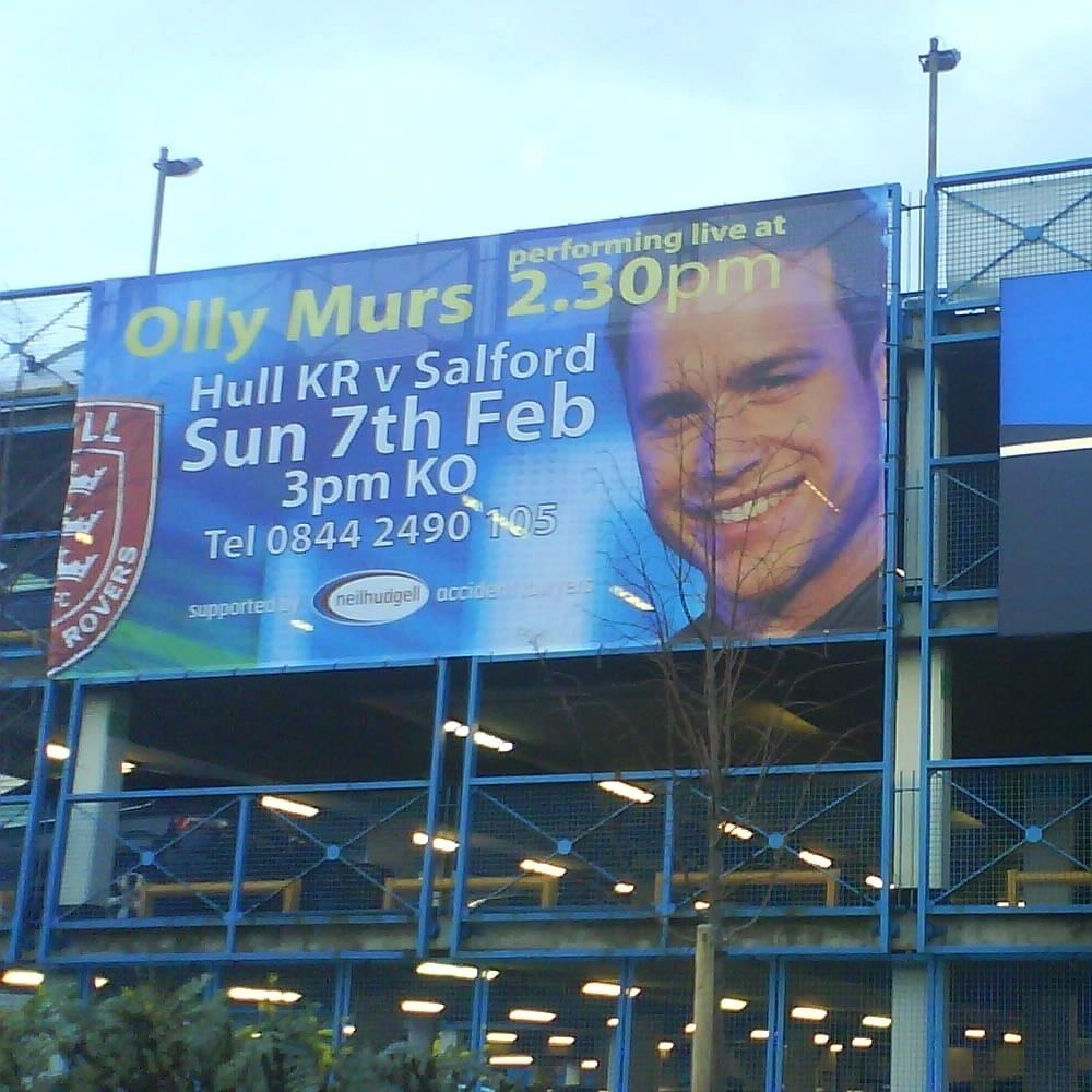 Large printed banners displayed inside a prestige car dealership